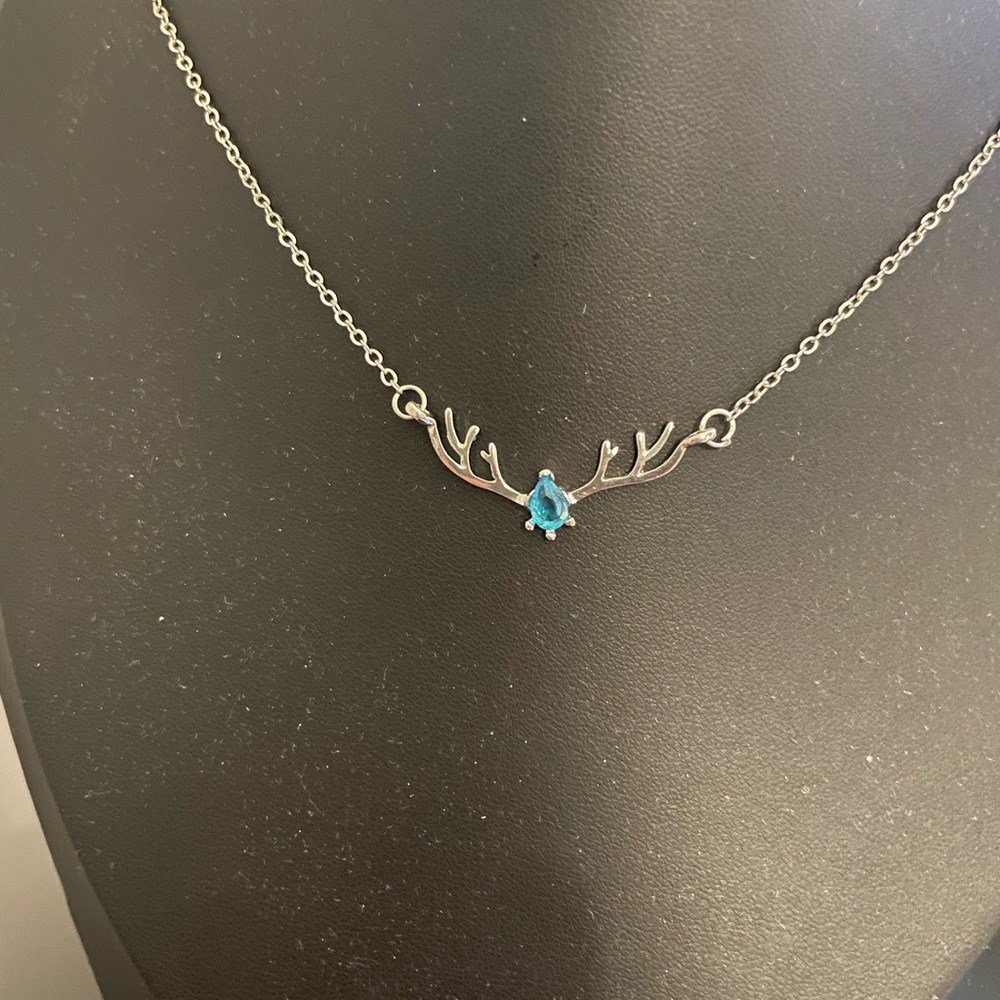 Elegant Silver Antler Necklace with Blue Gem